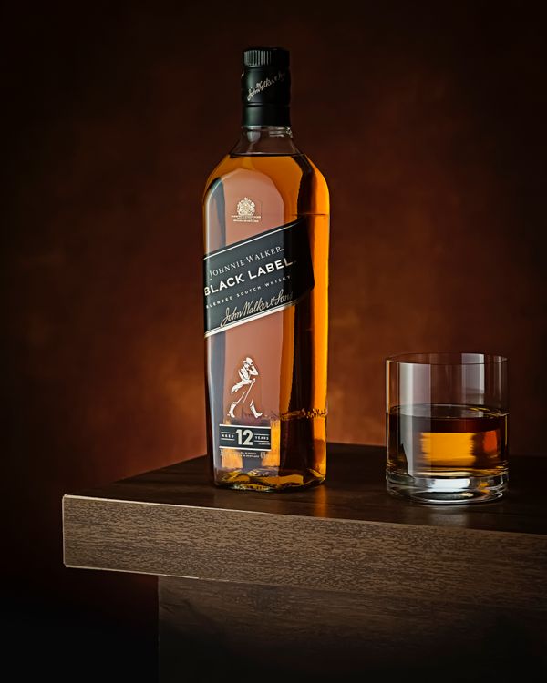 Chai rượu whisky Chivas trên bàn gỗ sang trọng