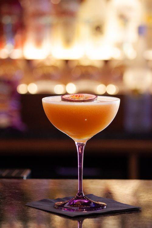 Ly vodka martini chanh dây trong không gian bar ấm cúng